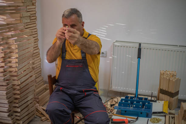 istock Senior man prepares honeycomb frames for beehives 2147534444