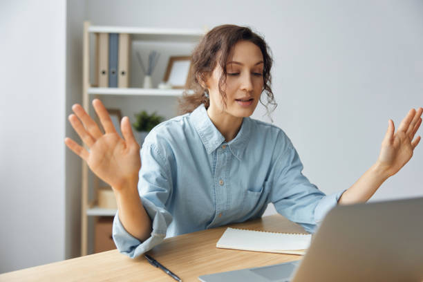 istock Raging evil curly awesome lady shocked by gadget laptop breakdown operational problems raising hands up sitting at home office. Irritated by bad gadget work businesswoman trying to calm down 2147534465