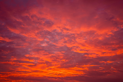 Bright red sunset. Dramatic evening sky with clouds.
