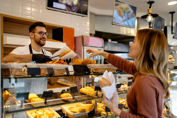 istock Woman and baker in friendly exchange 2147537235
