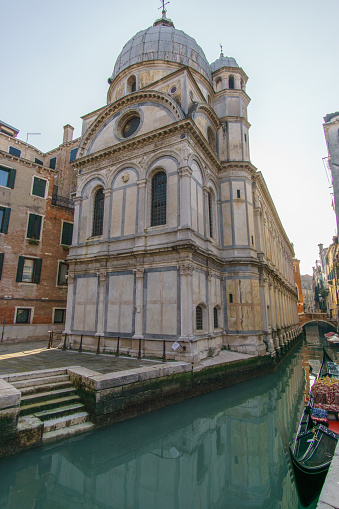 Church of Santa Maria dei Miracoli in front of a typical canal with gondola, Venice, Veneto, Italy