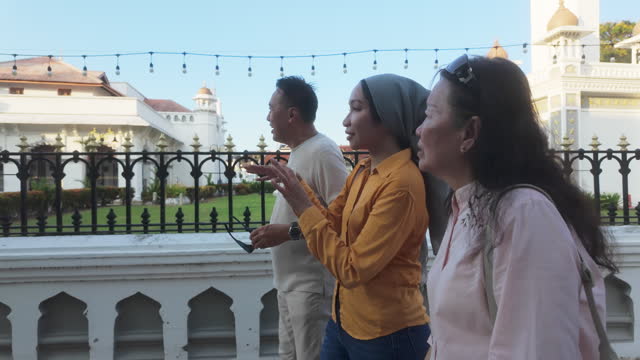local tour guide explaining to Chinese senior couple on George town mosque, Penang Island