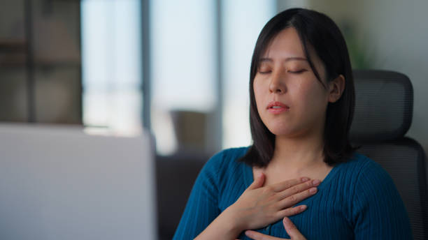 istock Freelancer businesswoman taking break from working and relaxing and doing breathing exercise in living room at home 2147542626