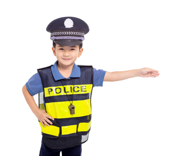 istock child dressed as a police officer standing before white background 2147542652