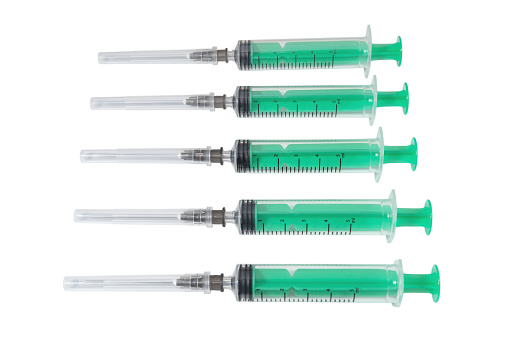 Disposable plastic syringes isolated on white. Medical equipment and instruments