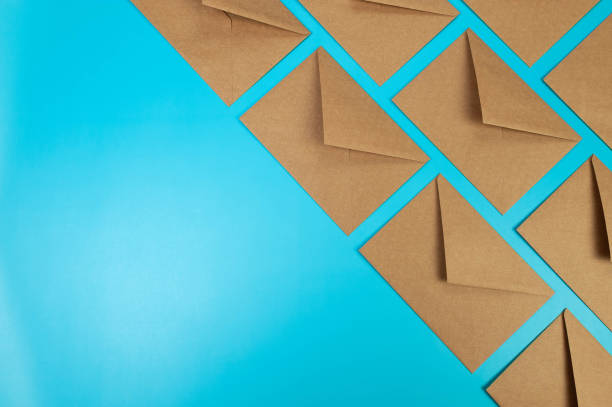 istock Top view of brown kraft envelopes on blue background. 2147542834
