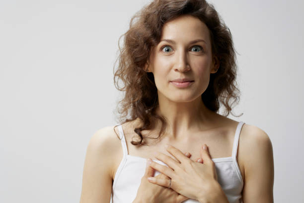 istock Overjoyed shocked surprised happy curly beautiful woman in basic white t-shirt fold hands on chest posing isolated on over white background. People Emotions Lifestyle concept. Copy space 2147542961