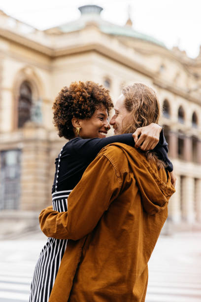 istock Affectionate embrace on the city streets by a diverse couple 2147543019