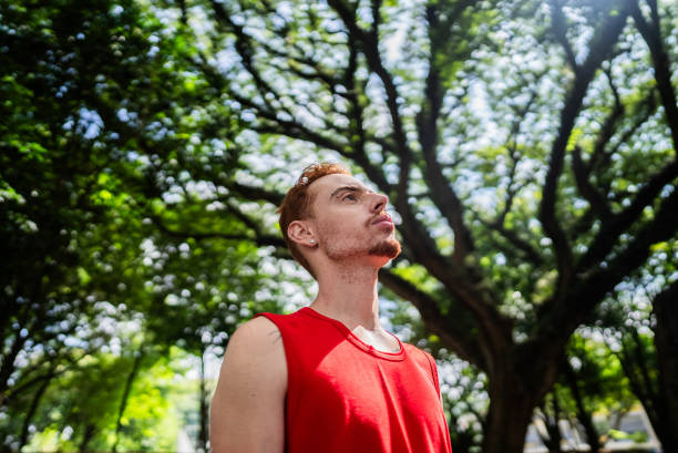 istock Young man looking away contemplating on public park 2147543213