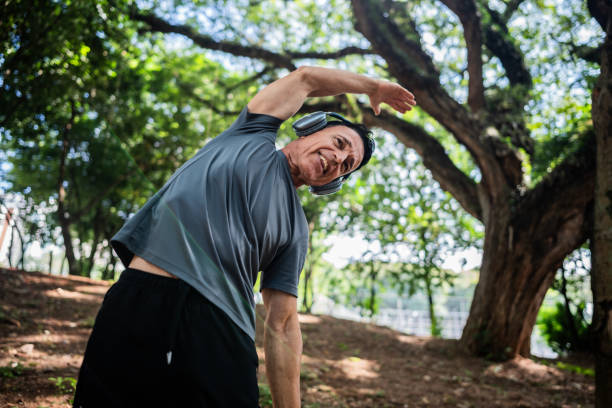 istock Senior man stretching on the public park 2147543240