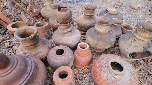 Numerous weathered clay pots stacked together