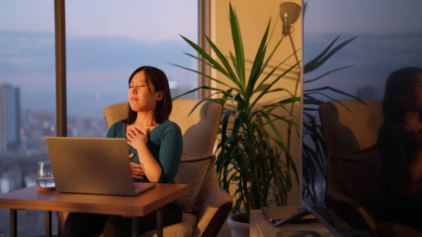istock Freelancer businesswoman taking break from working and relaxing and doing breathing exercise in living room at home 2147543419