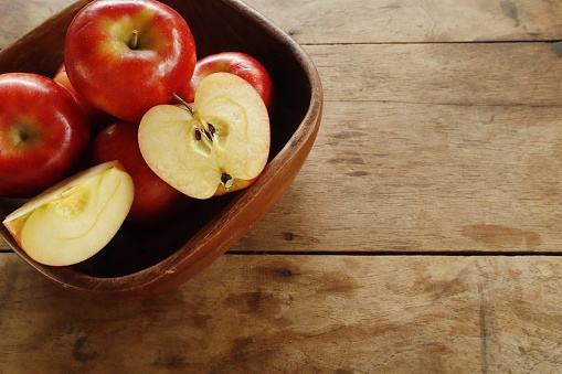 Fresh organic Red pop apple fruit welcomes summer in beautiful colors on a wooden table.