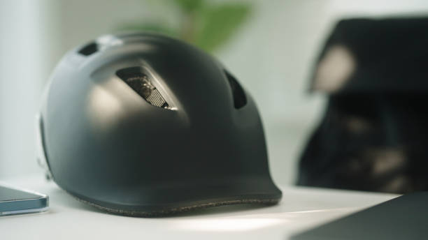 Close-up hand of man grabbing helmet of bicycle and go out.