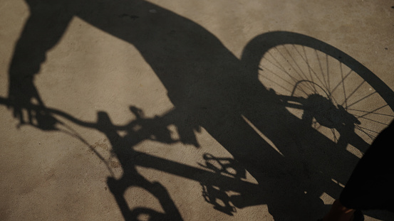 Shadow of man beginning to bike.