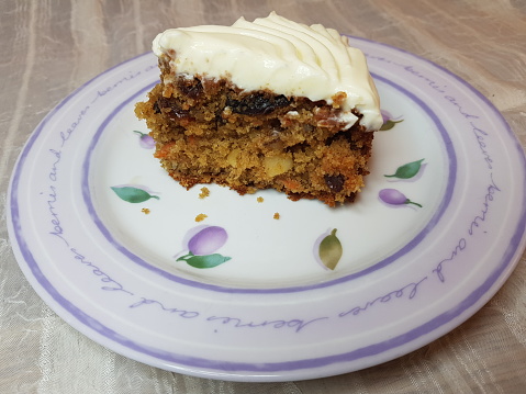 Side view of a slice of a carrot cake with cream cheese frosting, Glasgow Scotland England