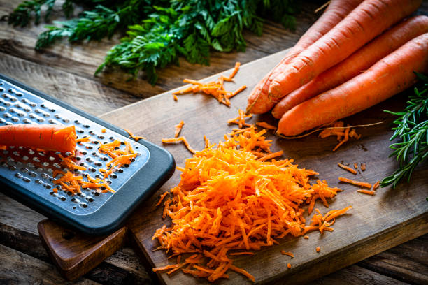 Fresh organic shredded carrots on cutting board. High resolution 42Mp studio digital capture taken with Sony A7rII and Sony FE 90mm f2.8 macro G OSS lens