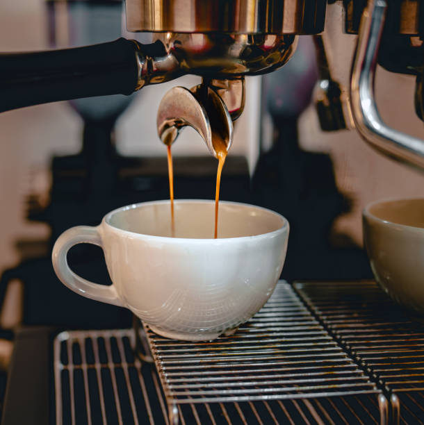 istock Coffee extraction from the coffee machine with a portafilter pouring coffee into a cup,Espresso poruing from coffee machine at coffee shop 2147544936