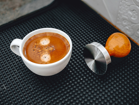 Hot espresso cup and coffee tamper