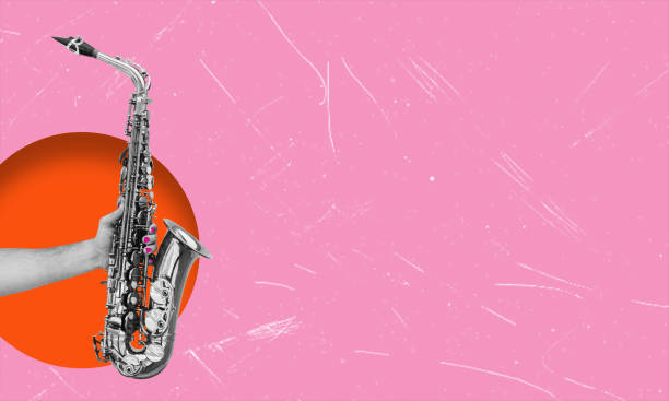 istock Abstract design with human hands holding a saxophone on a pink background. Classic sound. 2147546025