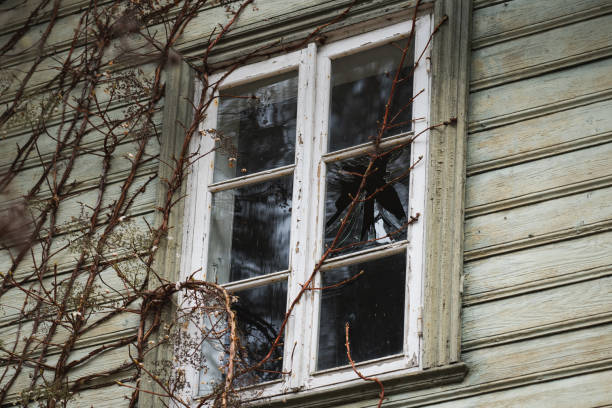 Broken window in an old wooden house. Close up photo