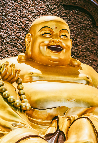 The golden statue of Buddha in the temple