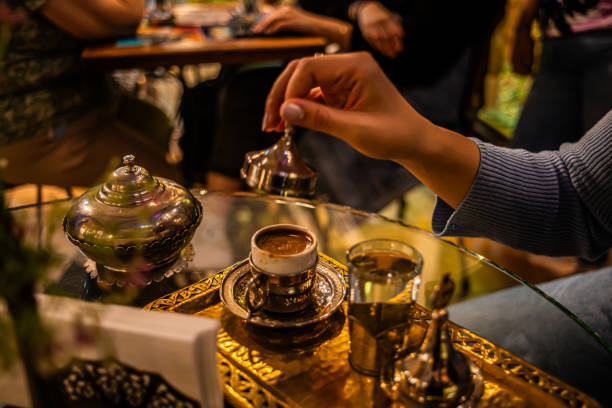 Aromatic Unveiling: Woman Opens Turkish Coffee Cap in Cafe