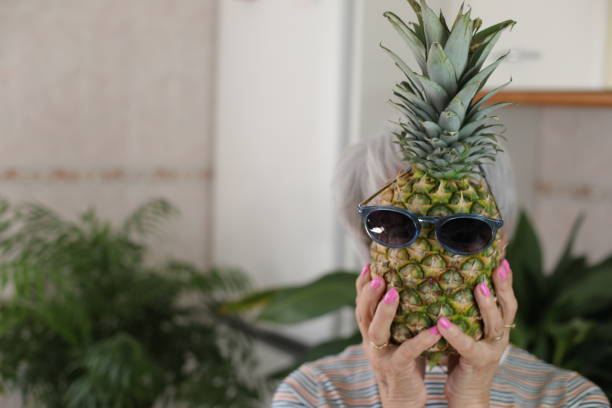 istock Senior woman holding a pineapple 2147547585