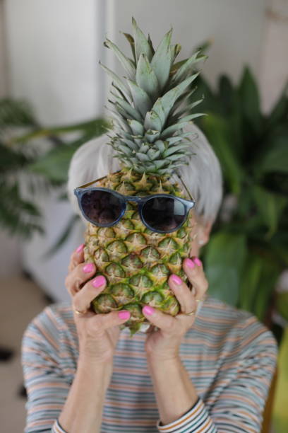 istock Senior woman holding a pineapple 2147547663