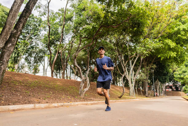 istock Young man running on the public park 2147548033