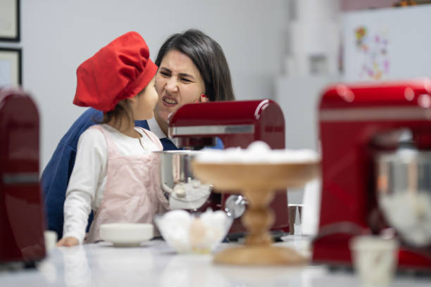 istock Cute little girl at cake making course 2147550175