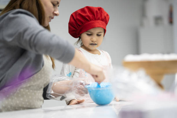 istock Cute little girl at cake making course 2147550214