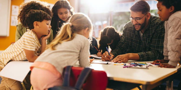 istock Group of elementary school kids having an art lesson with their teacher 2147550520