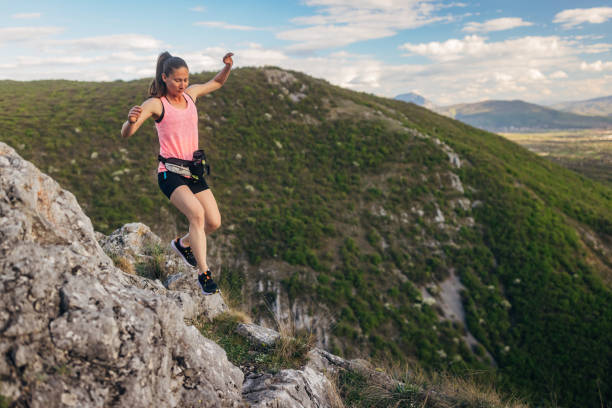 istock A female athlete overcomes unpredictable terrain and runs on a mountain 2147550711