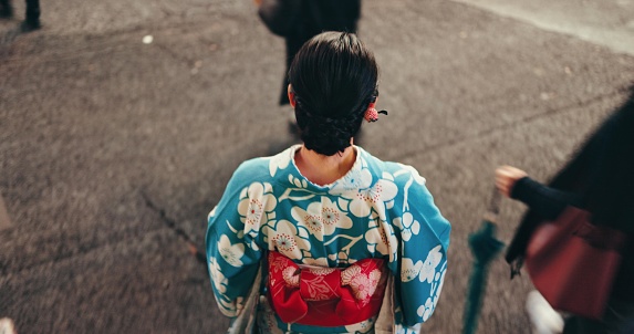 Japanese woman, kimono and travel on city for culture, respect and religion in heritage celebration. Young person, relax or traditional clothes in tokyo by back, steps or beauty in indigenous fashion
