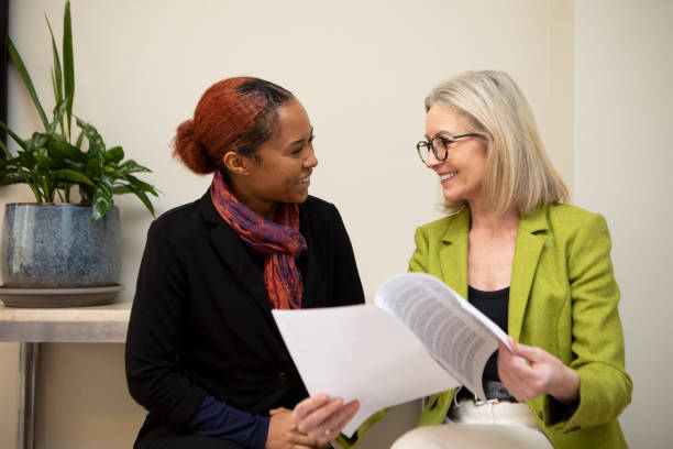 istock Two business colleagues sitting with paperwork and having a discussion 2147552171