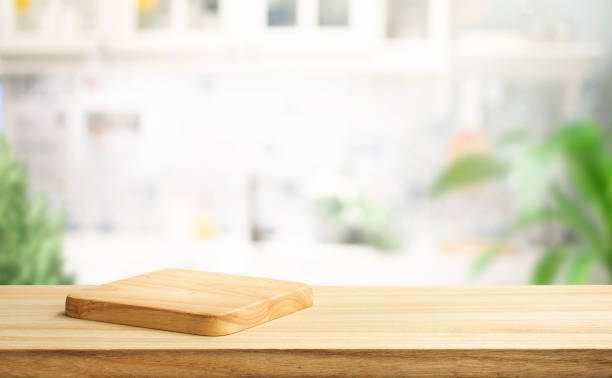 istock Selective focus.End grain wood counter top with cutting board on blur kitchen background 2147552512