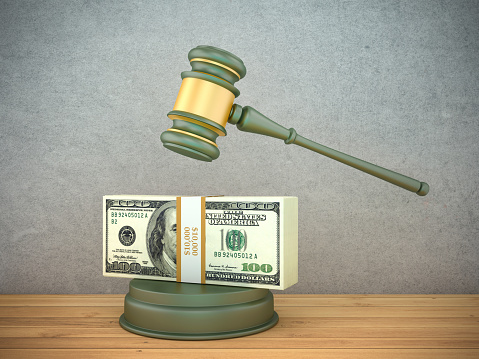 Law concept or auction concept. Dollar bills , judge's gavel on white background. closeup of a gavel on cash, from above