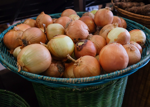 Close-up shot of fresh onions in supermarket retail display