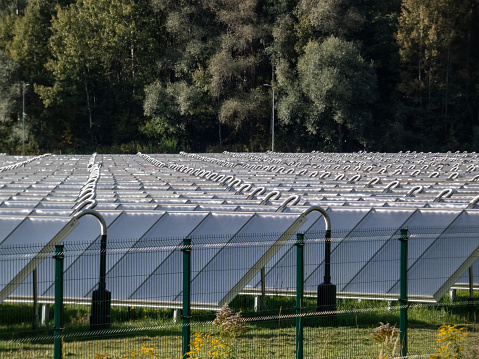 Field of PV solar panels providing alternative green energy used for heating. Solar thermal collectors generating electricity, use of renewable energy resources