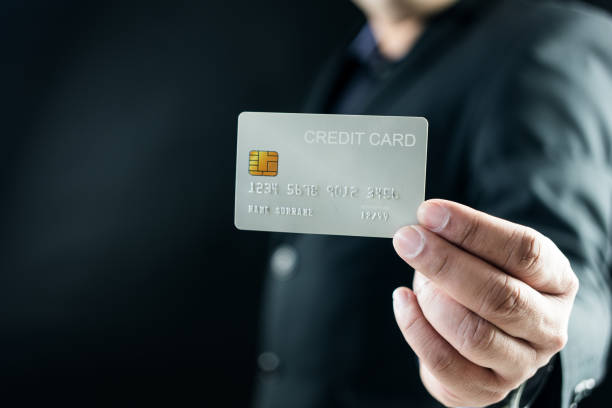 istock Businessman in suit showing a credit card 2147560268