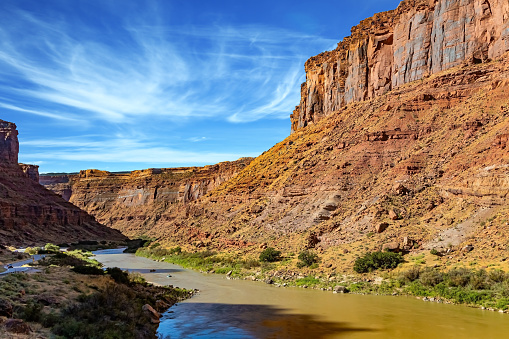 The road runs along the shore of the Colorado River. Utah Red Sandstones. The grandiose landscapes of America.