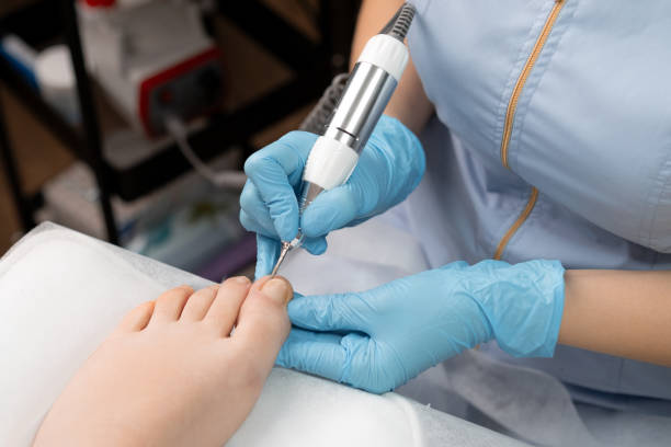 istock A pedicure expert in rubber gloves, performs a hardware pedicure for woman, utilizing a nail drill 2147562325