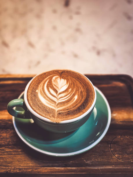 istock Hot cappuccino coffee in a mug Placed on the table in a warm atmosphere. 2147562347