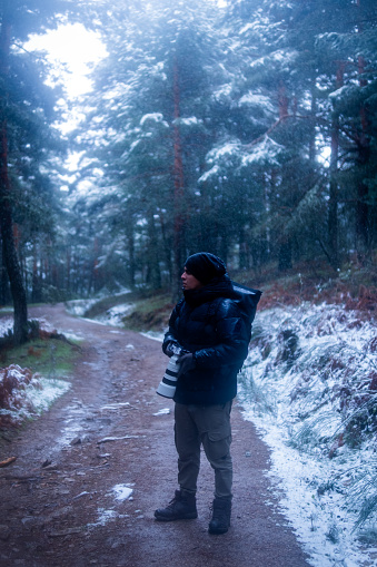 Man trekking amidst snowy landscape, advocating for ecotourism and environmental conservation.