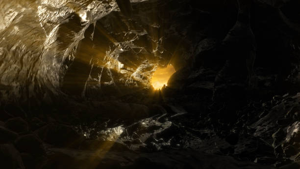 istock Dark cave with small water pond and rays of sun 2147566578