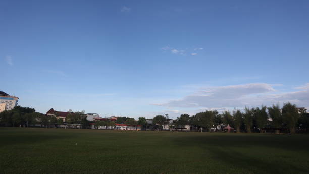 istock football field with blue sky background 2147568843