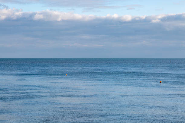 The calm ocean at Eastbourne, with a blue sky overhead