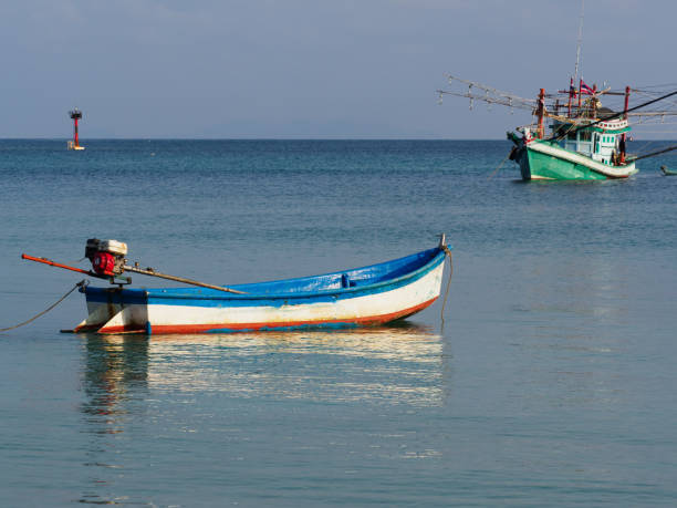 istock Fishing boat anchored against a clear sky 2147570269