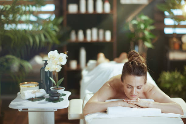 istock relaxed modern woman in spa salon laying on massage table 2147572010